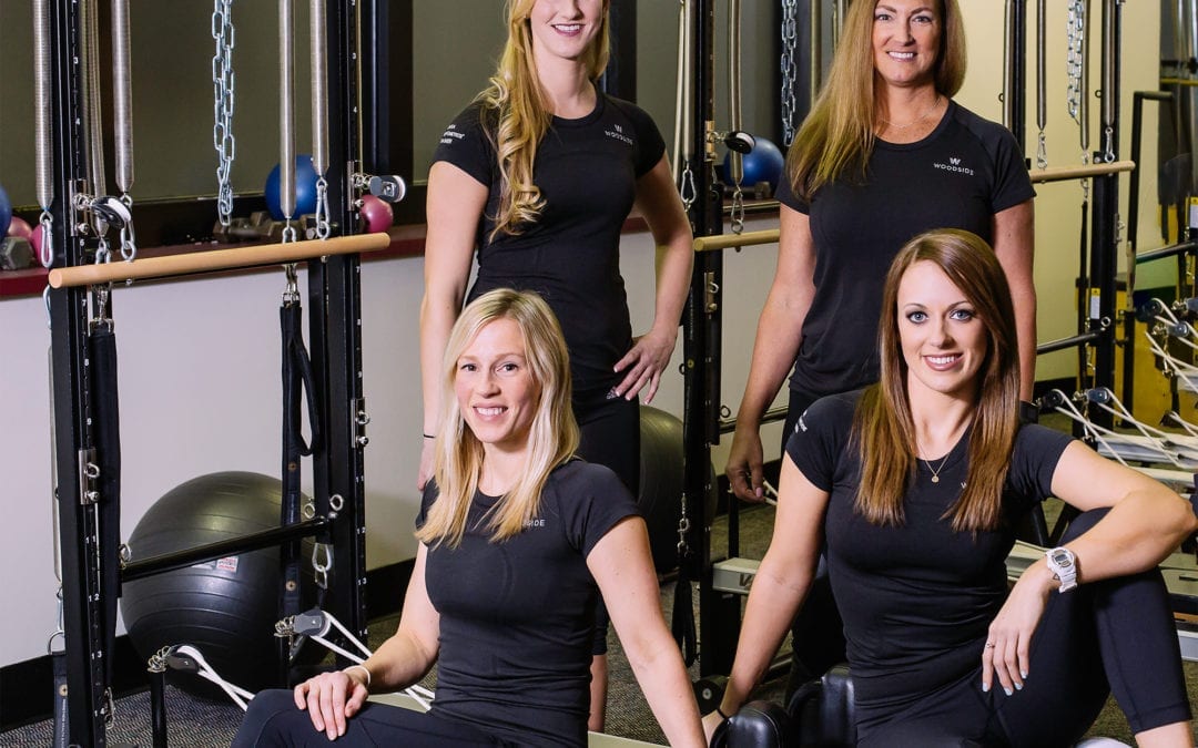 Pilates instructor training women at a gym