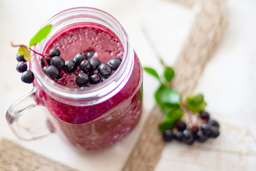 Berry smoothie in a mason jar with blueberries