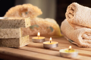 Towels and tea candles on a table at a wellness center