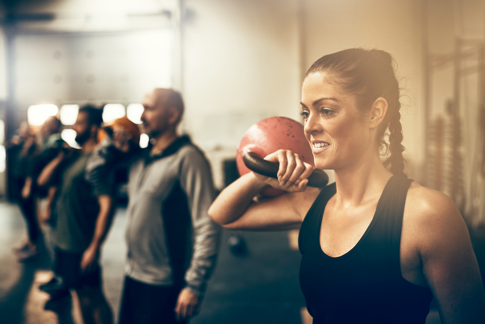 A young woman participates in group fitness in Kansas City