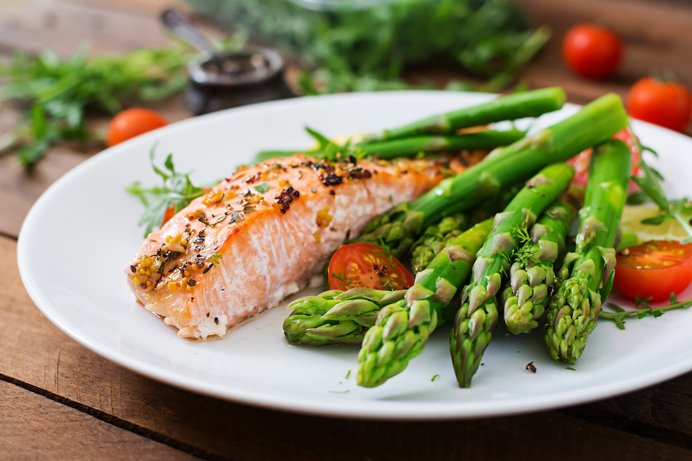 A plate of baked salmon and vegetables