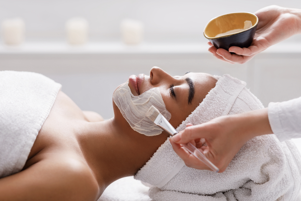 A woman gets a facial at the spa