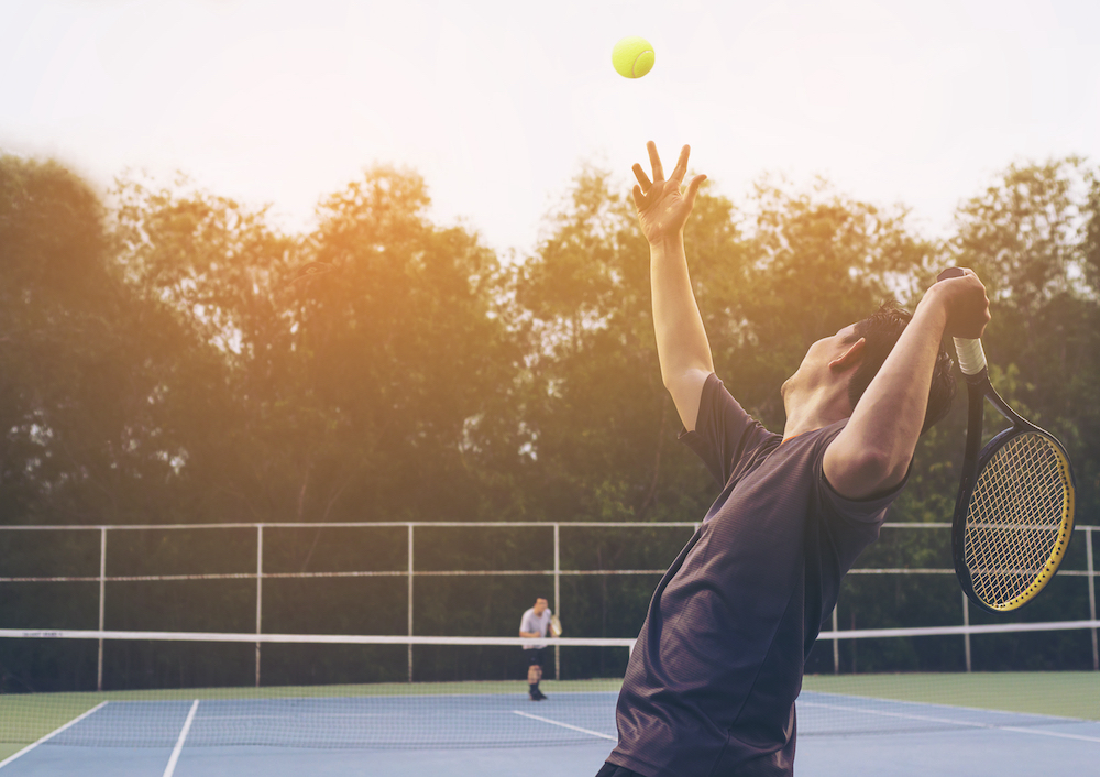 A group of friends play a tennis match together