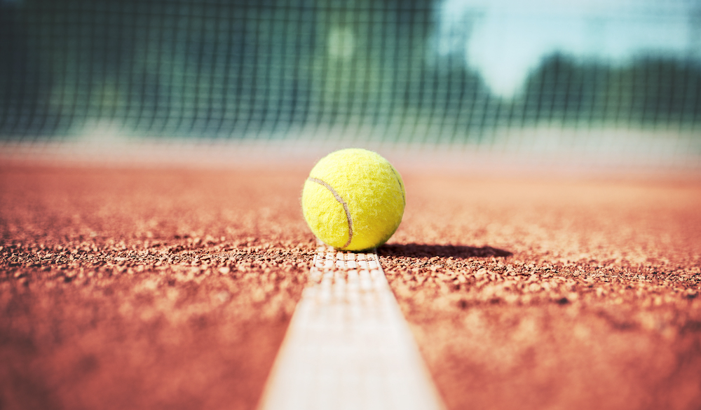 A tennis ball on an outdoor court