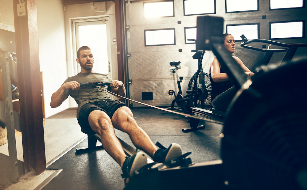 A man uses a row machine to work out at the gym near Kansas City