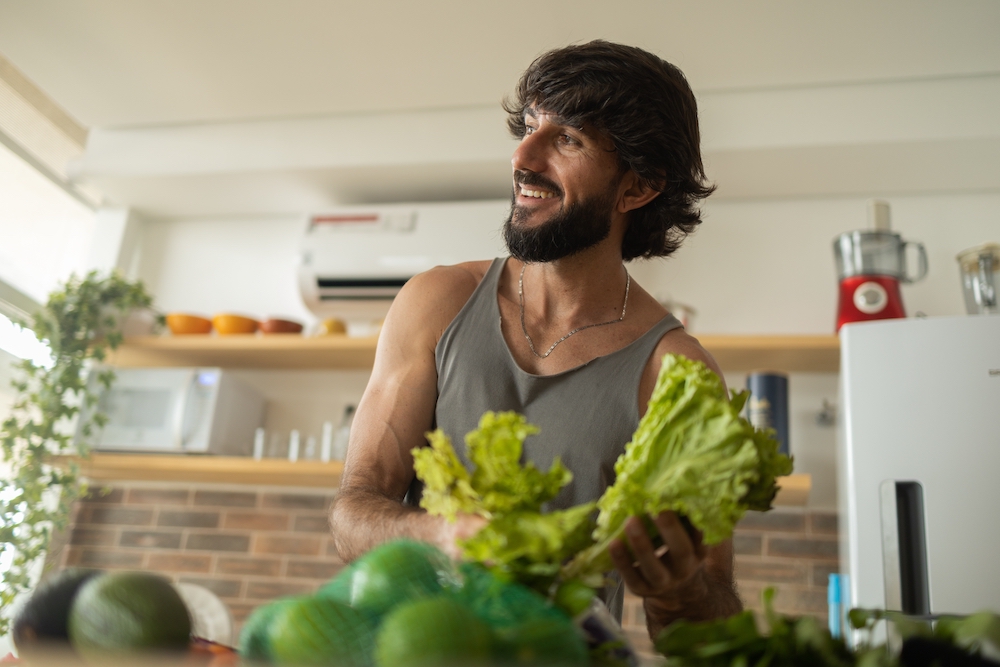 A man cooking with green vegetables