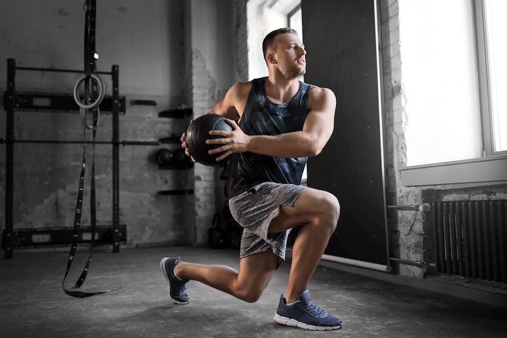 A fit man training with a medicine ball at the gym near the Plaza in Kansas City
