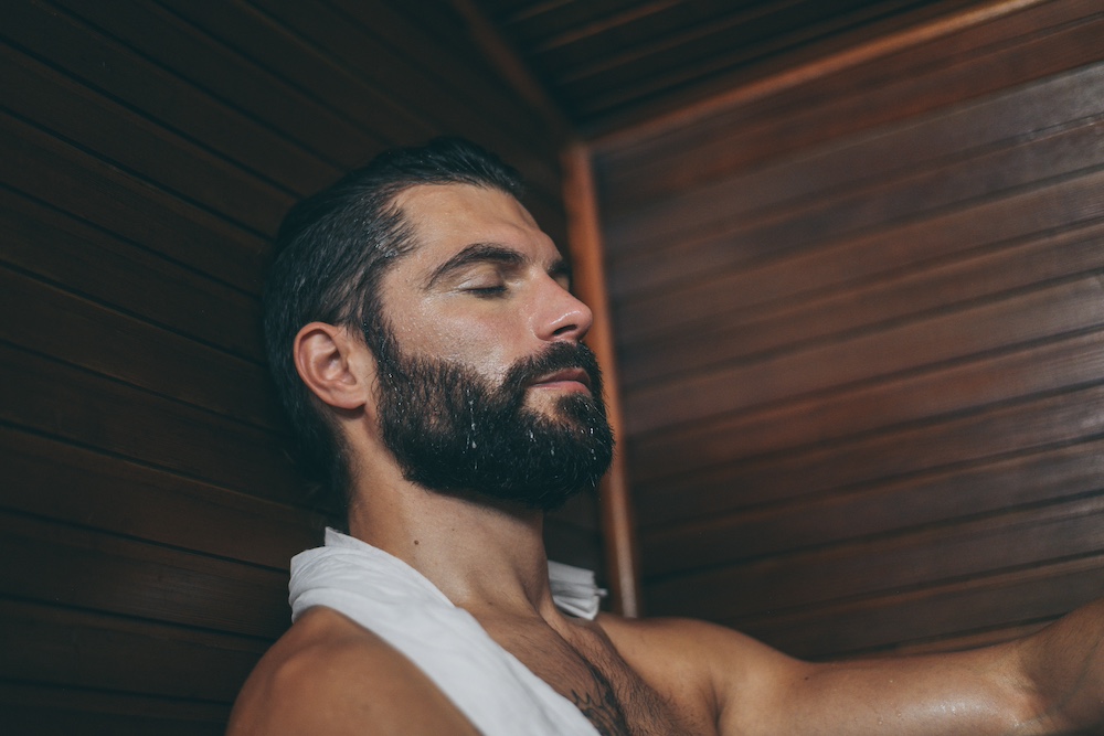 A man relaxes in the sauna at the KC wellness center