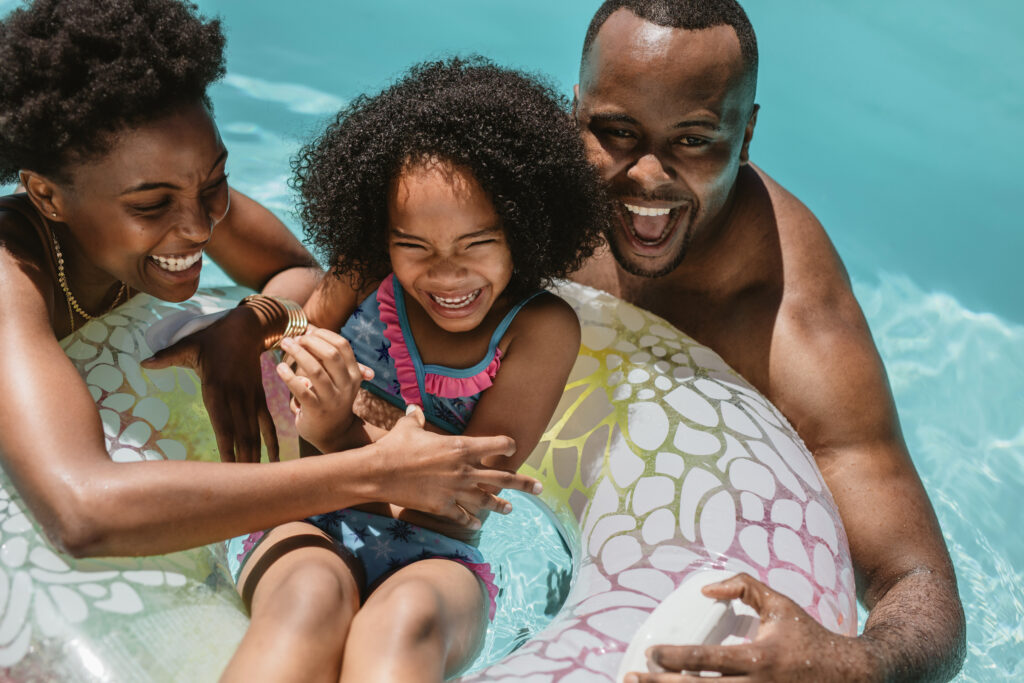 Happy family swimming at family pools near me.