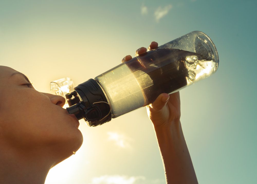 Woman drinking water at KC wellness center.