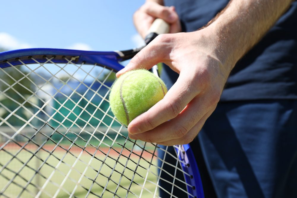 Tennis racket in adult tennis lessons Kansas City.