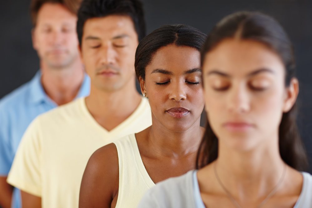 Group of men and women practicing mindfulness at westwood fitness