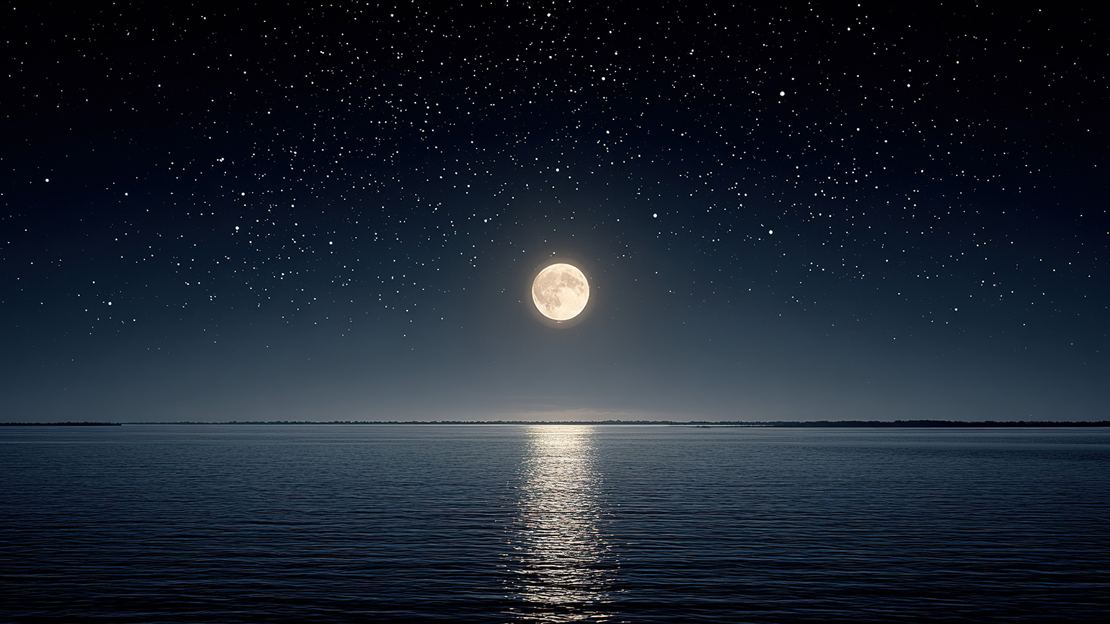Full moon over a still body of water at night.